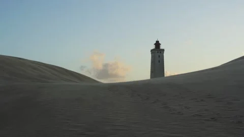 Rubjerg knude lighthouse standing amidst shifting sand dunes Stock Footage 338091680