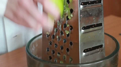 Rubs the apple on grater Stock Footage 48648382