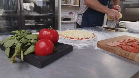 Rubs cheese on the grater Stock Footage 244951072