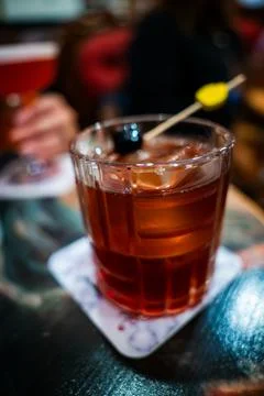 Ruby brown cocktail on marble coaster in Valletta, Malta bar 写真素材