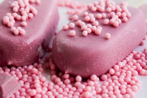 Ruby chocolate balls and ice cream on the white surface Stock Photos