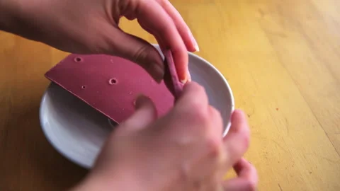 Ruby chocolate bar opening person hand eating piece with filling Video stock 166644234