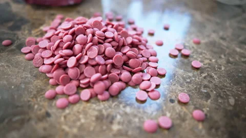Ruby chocolate callets piled up on the counter tempered chocolate confectionery Video stock 239481894