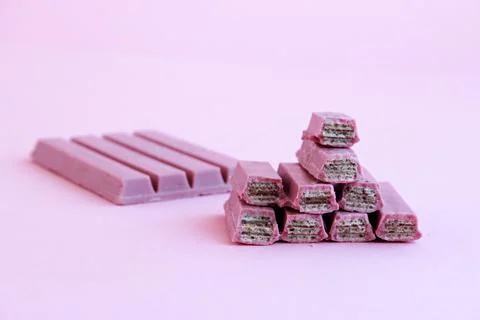 Ruby chocolate covered wafers sliced on pastel pink ground Stock Photos