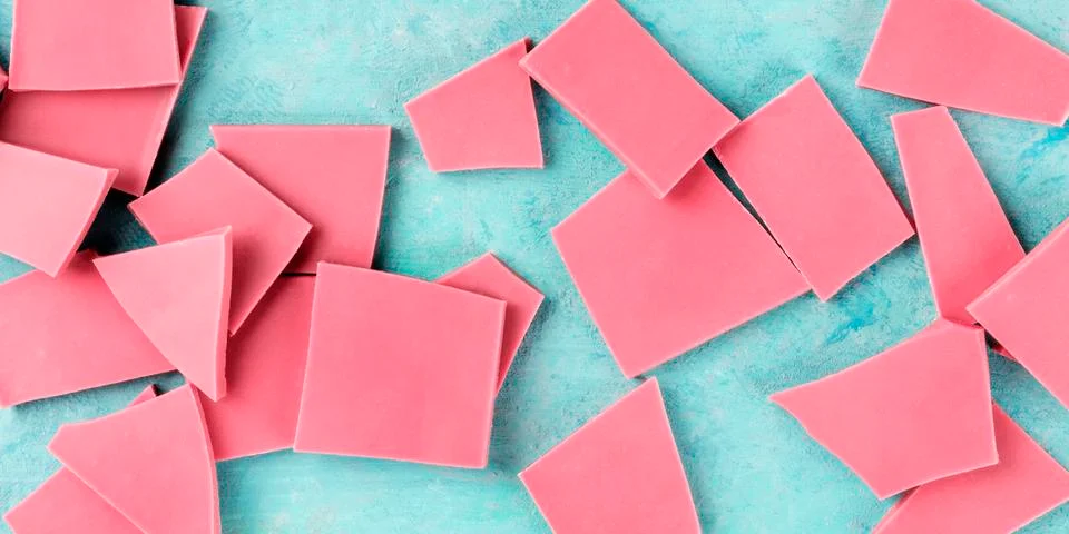 Ruby chocolate, overhead panoramic shot on a blue background Stockfoto's
