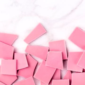 Ruby chocolate, overhead square shot on a white marble background with copyspace 写真素材