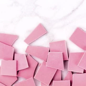 Ruby chocolate, overhead square shot on a white marble background with copyspace Stock Photos