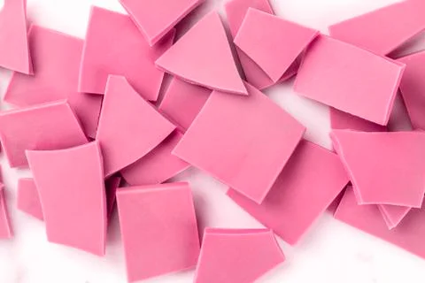Ruby chocolate pieces, shot from the top on a white marble background 스톡 사진