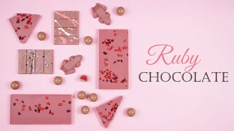 Ruby chocolate selection flat lay on pink background stop motion animation. Video stock 122853966