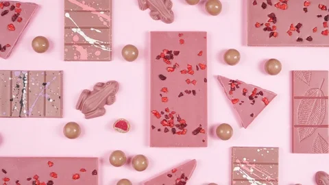 Ruby chocolate selection flat lay overhead on pink background. Video stock 122856395