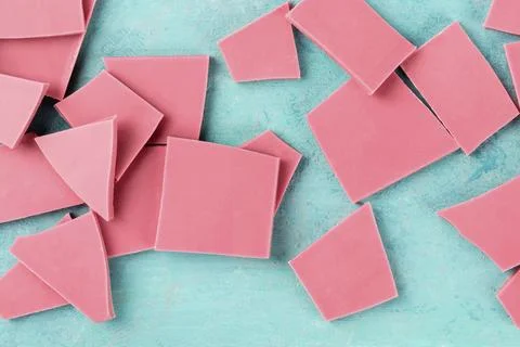 Ruby chocolate, shot from the top on a blue background Stock Photos