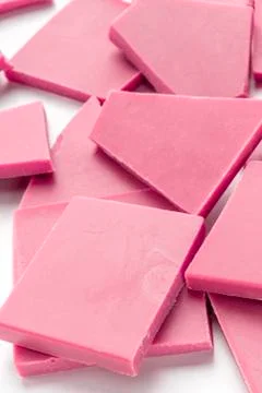 Ruby chocolate slices, a close-up of a heap on a white background 스톡 사진