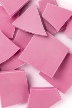 Ruby chocolate slices, a close-up overhead shot of a heap on a white background Stock Photos