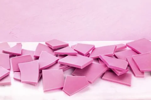 Ruby chocolate slices on a pink background with a place for text Stock Photos