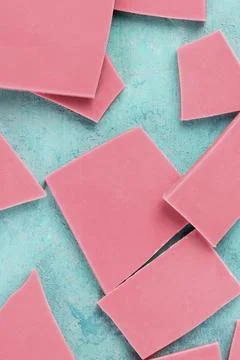 Ruby chocolate slices, top shot on a blue background Stock Photos