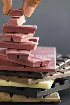 Ruby Chocolate in stack with other type chocolates,vertical image Stock Photos