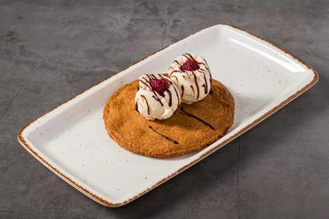 Ruby cookie dessert topped with vanilla ice cream and chocolate Stock Photos