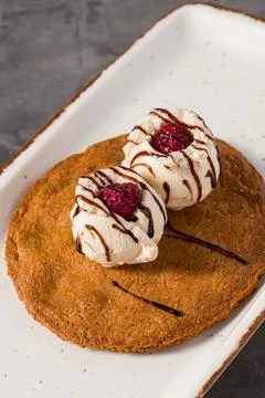 Ruby cookie dessert topped with vanilla ice cream and chocolate Stock Photos