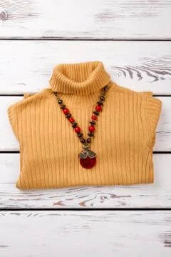 Ruby decorated necklace on sweater. Stock Photos