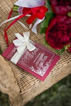 Ruby flowers are lying on a wicker chair 2799. Stock Photos