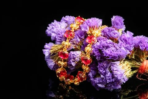 Ruby gold bracelet with flower on black background Stock Photos
