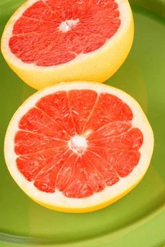  Ruby grapefruit close-up Close-up of a half cut ruby grapefruit over a gr... 스톡 사진