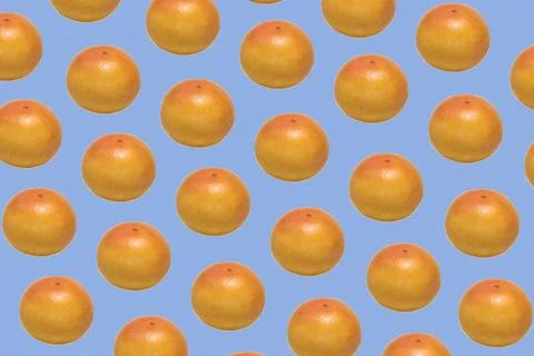 Ruby grapefruit pattern Pattern made of whole ripe ruby grapefruit on blue... 写真素材