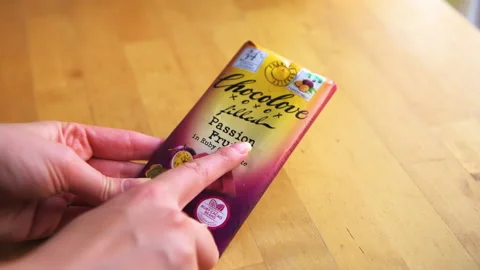 Ruby passion fruit chocolate bar with sign label Chocolove brand opening Stock-Footage 166644938