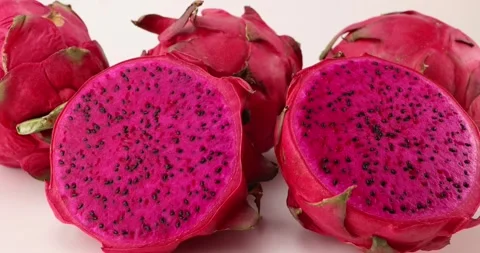 Ruby red exotic cactus dragon fruit whole cut half on white background Stock Footage 270142806