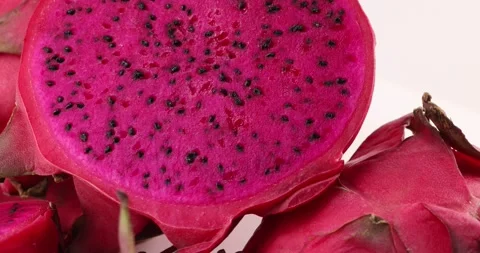 Ruby red exotic cactus dragon fruit whole cut half on white background Stock Footage 270143447