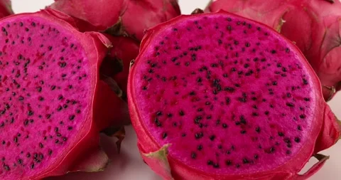 Ruby red exotic cactus dragon fruit whole cut half on white background Stock Footage 270143496