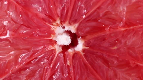 Ruby red grapefruit closeup macro pulp flowing squeezing juice Stock Footage 158930240