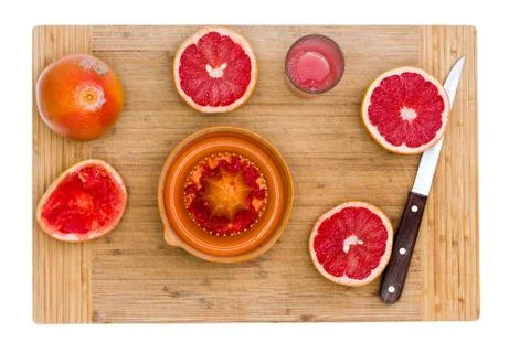 Ruby Red Grapefruit with Juicer and Sharp Knife Stock Photos