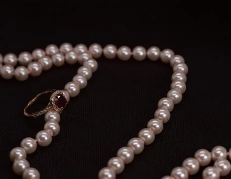 Ruby ring with pink pearl necklace Stock Photos