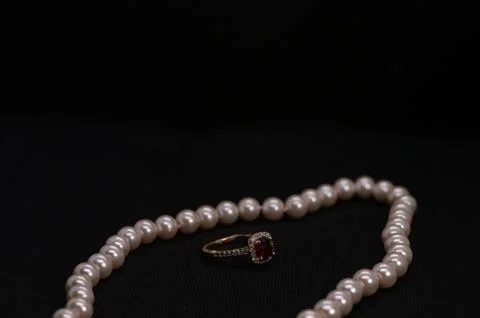 Ruby ring with pink pearl necklace 스톡 사진
