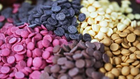 Ruby white and dark chocolate callets closeup - Tempered chocolate confectionery Video stock 239382894