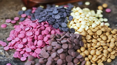 Ruby white and dark chocolate callets closeup - Tempered chocolate confectionery Stock Footage 239681638