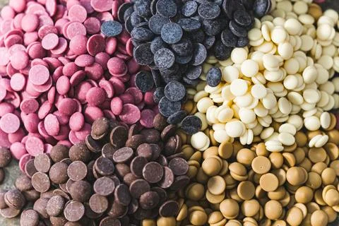 Ruby white and dark chocolate callets closeup - Tempered chocolate confectionery Stock Photos