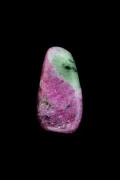 Ruby zoisite jewel stone texture on black background. Macro closeup. Stock Photos