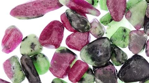 Ruby zoisite jewel stones heap up texture on light white isolated background. Stock Footage 220390176
