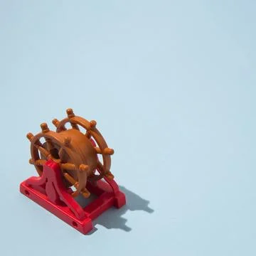 Rudder with a sharp shadow, in the lower left corner with copy space on a b.. Stock Photos