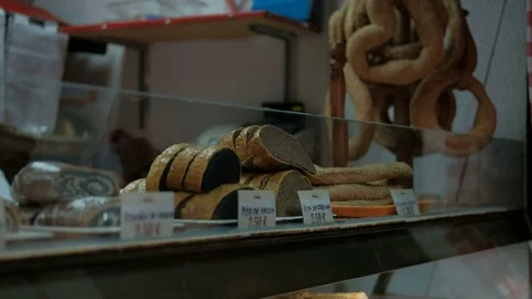Ruddy pastry lying on showcase in bakery indoors. Stock Footage 76879736