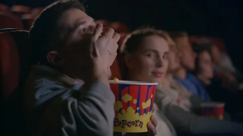 Rude man eating popcorn at cinema. Rude manners at movie hall Stock Footage