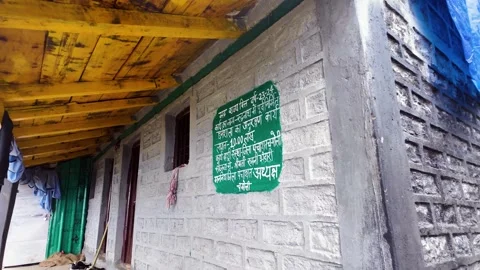 Rudranath Temple stone wall with painted Hindi signage Stock Footage 346582233