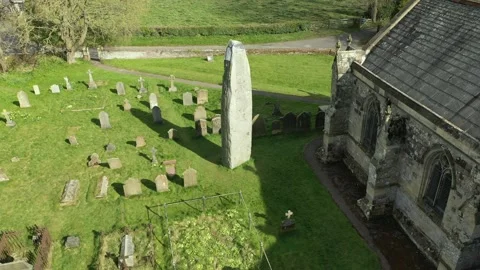 Rudston Monolith Stunning Drone Pull Back Tilt- Up, Britain's Tallest Stone 4K Stock Footage 196186619