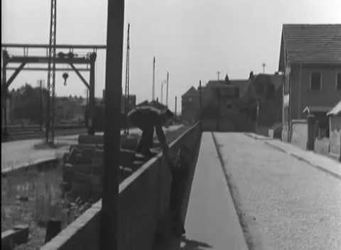 RUESSELSHEIM, GERMANY - 1945: Folded bundle - Men work around masonry blocks Stock Footage 344487733