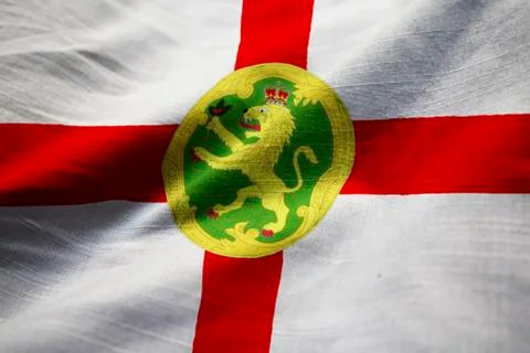 Ruffled Flag of Alderney in Wind Stock Photos