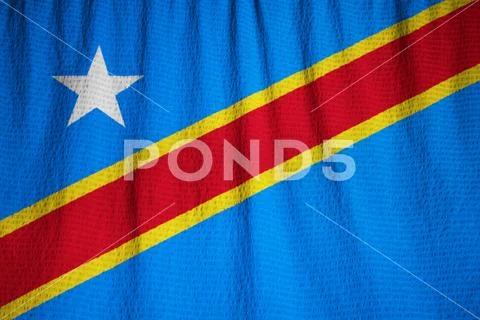 Ruffled Flag of Democratic Republic of the Congo Blowing in Wind Stock Photos
