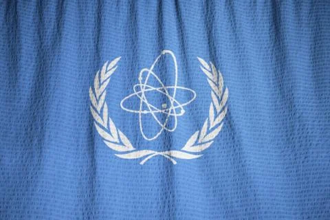 Ruffled Flag of IAEA Blowing in Wind Stock Photos