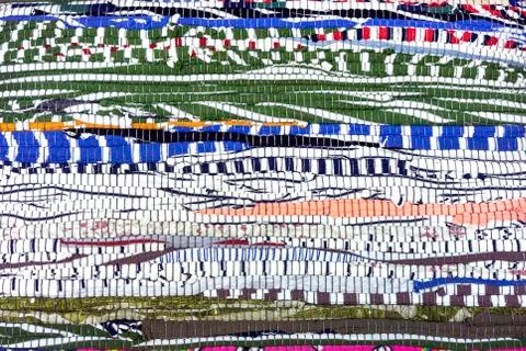 Rug of pieces of cloth. Texture and background of patchwork carpet. 库存照片